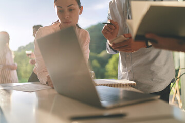 Cropped portrait of team lead woman at conference with colleagues