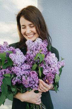 Smiling woman with bouquet of lilac