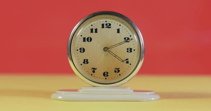 Stop motion animation. Old alarm clock shot close-up. Worn dial and hands. Vintage stand in scratches. However, he is perfectly fine. Works so far as new. Time lapse.