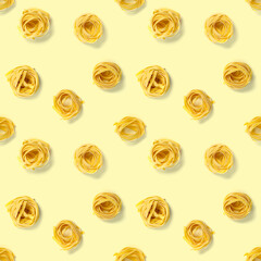 Seamless pattern from Italian tagliatelle pasta. raw pasta fettuccine, pop art background, flat lay. Italian raw nest pasta isolated on yellow.