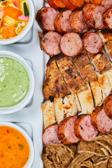 roasted mix of meats chicken and chorizos