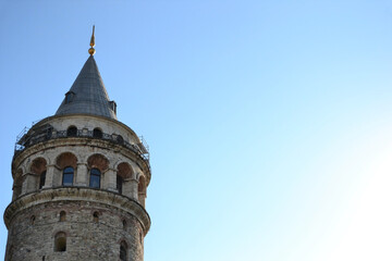 Tip of Galata tower in Istanbul on blue sky background.