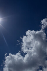 Blue sky with white abstract shape clouds and sun light up view