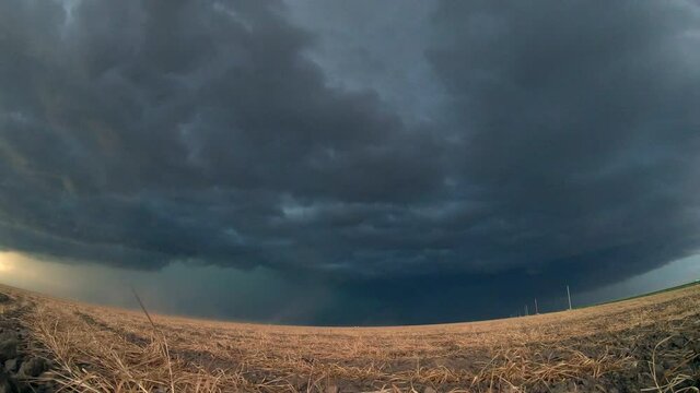 Large, powerful tornadic supercell storm moving over the Great Plains during sunset, setting the stage for the formation of tornados across Tornado Alley.