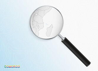 Magnifier with map of Comoros on abstract topographic background.