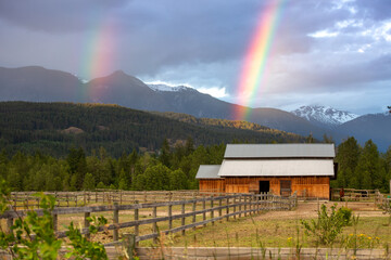 Rainbows over farm in Pemberton, British Columbia
