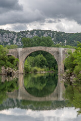 Fototapeta na wymiar View of the river Herault in the South of France with the bridge of Saint Etienne d'Issensac in the background