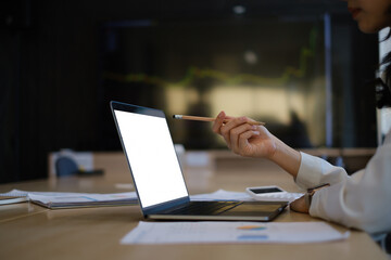 Business woman trader investor using laptop with cryptocurrency stock market graph on background. stock chart, investment concept.