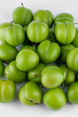fresh and green plum on white background