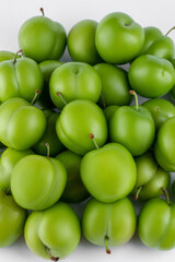 fresh and green plum on white background