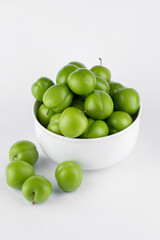 fresh and green plum on white background
