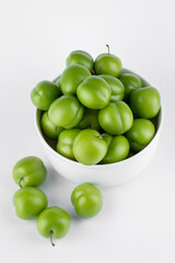 fresh and green plum on white background