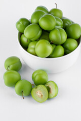 fresh and green plum on white background