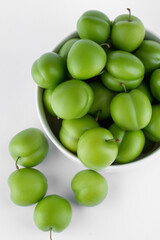 fresh and green plum on white background