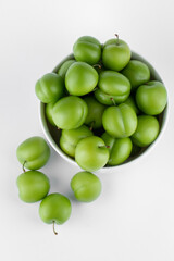 fresh and green plum on white background