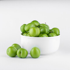fresh and green plum on white background
