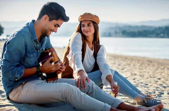Beautiful young couple having fun on the beach. Lifestyle, love, dating, vacation concept