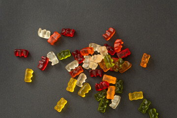 chewing candies of different colours are scattered on a gray background