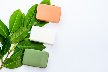 cosmetic flat lay: craft soap of white, green and red colours with natural elements on a white background