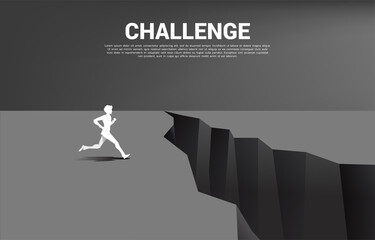 silhouette of businessman running to jumping over the gap. concept of business challenge and courage man