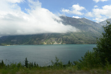 Scenic view of mountains, trees and a lake at Glacier National Park in Montana