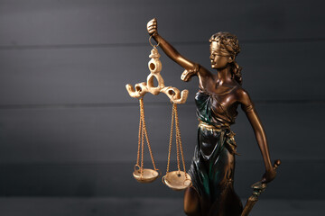 statue of justice on wooden background