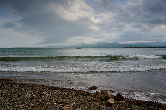Foamy waves of Lake Sevan breaking on a beach on a gloomy day in Armenia