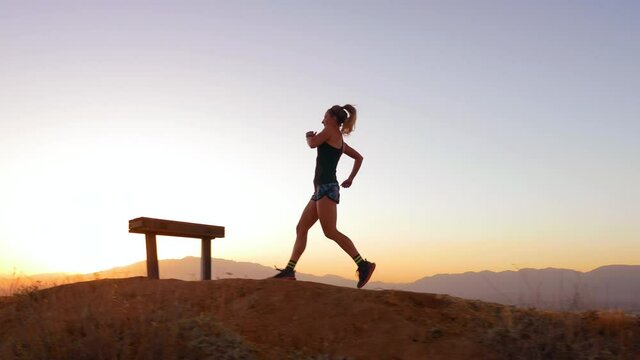 Woman Trail Running to Hilltop at Sunset 4K