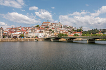 Fototapeta na wymiar City of Coimbra in the margins of the Mondego river in Portugal. Landscape view of Coimbra, Portugal