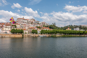Fototapeta na wymiar City of Coimbra in the margins of the Mondego river in Portugal. Landscape view of Coimbra, Portugal