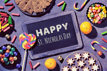 Text Happy St Nicolas Day on blackboard, chalk board. Traditional holiday in Germany and Western...