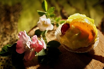 A small dessert with vanilla cream and fruit in a paper basket.