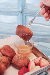 Traditional French beignets doughnuts with strawberry and powdered sugar. Usually yeasted and...