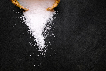 Sea salt on black background.