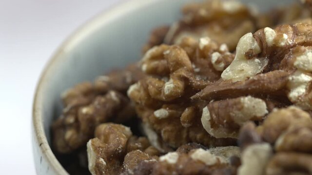 Walnuts Close-Up Macro 4K Shot of Nuts Rotating. Nuts Spinning In Bowl. Protein Plant Based Raw Vegan Food. Health And Vegetarian Foods. Healthy Breakfast Ingredients. Macro 4K Shot.