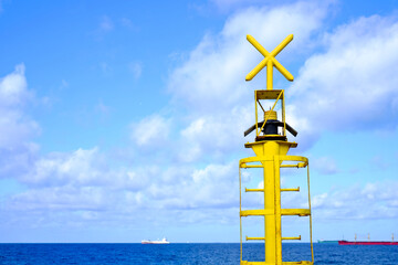 Yellow navigation mark with a cross - information for sailors about a danger to navigation.