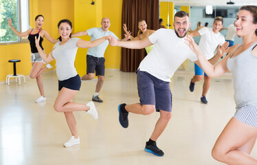 Fototapeta na wymiar Dancing couples learning swing at the dance class
