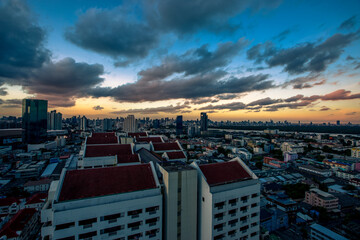 The high angle background of the city view with the secret light of the evening, blurring of night lights, showing the distribution of condominiums, dense homes in the capital community