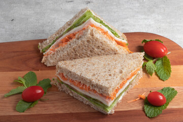healthy sandwich with integral bread, carrots, ham, lettuce and mozzarella .
