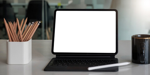 Blank screen Laptop computer and poster workspace background in modern office