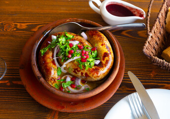Georgian homemade sausages Kupaty, traditional caucasian dish served with cilantro and pomegranate