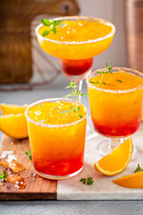 Tequila sunrise margarita cocktail with ice, refreshing drink