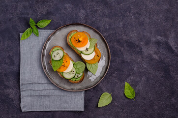 Sandwiches with vegetables, cheese and green sauce