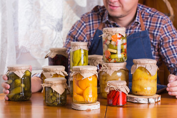 Young man holding in hands preserved food