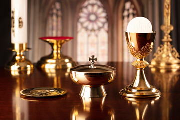 First Holy Communion. Catholic religion theme. Crucifix, the Cross and Golden chalice and wafer on...