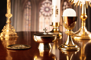 First Holy Communion. Catholic religion theme. Crucifix, the Cross and Golden chalice and wafer on...