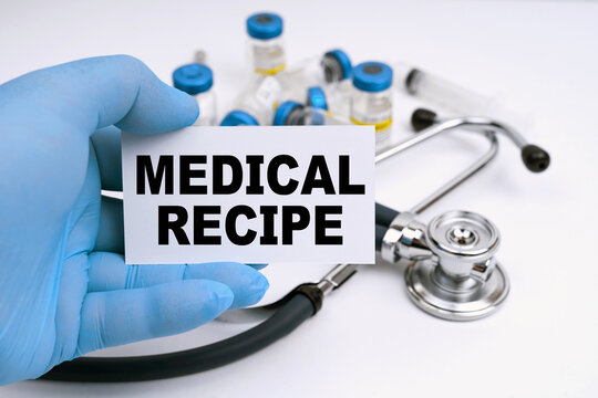 There Is A Stethoscope On The Table, The Doctor Is Holding A Business Card With The Inscription - MEDICAL RECIPE