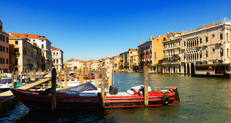 Fototapeta premium Motor boats parking in Grand Canal in Venice on background of impressive architecture of ancient buildings on banks of canal