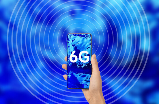 Holding a cell phone in his hand