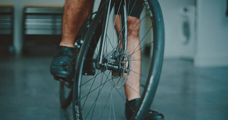 Athletic young man getting ready to go cycling, prepping his gear in the garage, active healthy lifestyle, performance athlete
